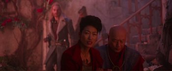 Movie still from “Mortal Engines” (2018), directed by Christian Rivers – A group of people standing in a room; Medium shot, Over the shoulder angle