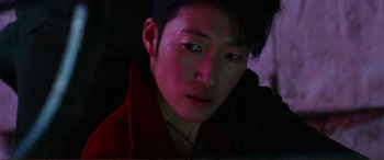 Movie still from “Mortal Engines” (2018), directed by Christian Rivers – A person wearing a red jacket; Close Up shot, High angle