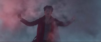 Movie still from “Mortal Engines” (2018), directed by Christian Rivers – A man in a red jacket standing in the fog; Medium shot, Low angle