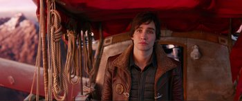 Movie still from “Mortal Engines” (2018), directed by Christian Rivers – A young man in a brown leather jacket; Close Up shot, High angle
