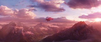 Movie still from “Mortal Engines” (2018), directed by Christian Rivers – An airliner flying over a mountain range at sunset; Extreme Wide shot, Low angle