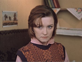 Movie still from “Moscow Does Not Believe in Tears” (1980), directed by Vladimir Menshov – A young woman with short brown hair wearing a sweater; Close Up shot, High angle