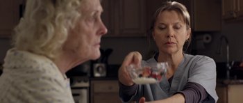 Movie still from “Mother and Child” (2009), directed by Rodrigo García – A woman holding a bowl of food in front of another woman in a kitchen; Close Up shot, Over the shoulder angle