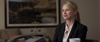 Movie still from “Mother and Child” (2009), directed by Rodrigo García – A woman sitting in a chair wearing a black jacket; Close Up shot, Over the shoulder angle