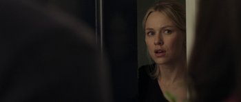 Movie still from “Mother and Child” (2009), directed by Rodrigo García – A woman looking at the camera in front of a mirror; Close Up shot, Over the shoulder angle