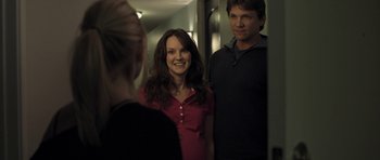 Movie still from “Mother and Child” (2009), directed by Rodrigo García – A woman standing next to a man in front of a mirror; Medium shot, Over the shoulder angle