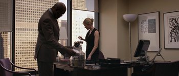 Movie still from “Mother and Child” (2009), directed by Rodrigo García – A man and a woman standing in front of a desk; Medium shot, Over the shoulder angle