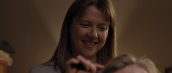 Movie still from “Mother and Child” (2009), directed by Rodrigo García – A person smiling at the camera; Close Up shot, Over the shoulder angle