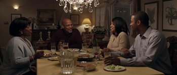 Movie still from “Mother and Child” (2009), directed by Rodrigo García – A group of people sitting at a dinner table; Medium shot, High angle