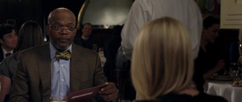 Movie still from “Mother and Child” (2009), directed by Rodrigo García – A man in a suit and tie holding a red folder; Close Up shot, Over the shoulder angle