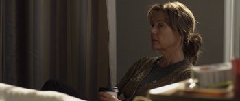 Movie still from “Mother and Child” (2009), directed by Rodrigo García – A woman sitting in a chair holding a coffee cup; Close Up shot, Over the shoulder angle