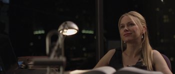 Movie still from “Mother and Child” (2009), directed by Rodrigo García – A woman sitting in front of a lamp in a dark room; Close Up shot, Over the shoulder angle