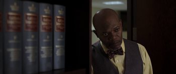 Movie still from “Mother and Child” (2009), directed by Rodrigo García – A man in a vest and bow tie looking at the camera; Close Up shot, Low angle