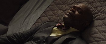 Movie still from “Mother and Child” (2009), directed by Rodrigo García – A person wearing a suit and a bow tie; Close Up shot, Overhead angle