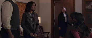 Movie still from “Mother and Child” (2009), directed by Rodrigo García – Two women dressed in business attire standing in front of a door; Medium shot, Over the shoulder angle