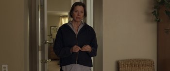 Movie still from “Mother and Child” (2009), directed by Rodrigo García – A woman standing in front of a mirror in a room; Medium shot, Over the shoulder angle