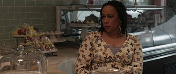 Movie still from “Mother and Child” (2009), directed by Rodrigo García – A woman sitting at a table in front of a bowl; Close Up shot, Over the shoulder angle