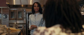 Movie still from “Mother and Child” (2009), directed by Rodrigo García – A woman standing in front of an oven in a kitchen; Close Up shot, Over the shoulder angle
