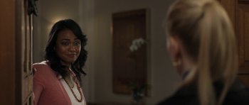 A woman standing next to a man in a room