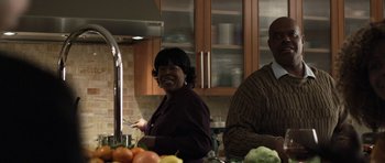 Movie still from “Mother and Child” (2009), directed by Rodrigo García – Two people in a kitchen preparing a meal together; Medium shot, Low angle