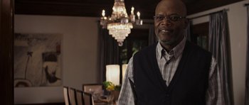 Movie still from “Mother and Child” (2009), directed by Rodrigo García – A man standing in front of a dining room table; Medium shot, Over the shoulder angle