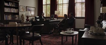 Movie still from “Mother and Child” (2009), directed by Rodrigo García – Two women and a man sitting at a desk in front of a computer; Wide shot, High angle