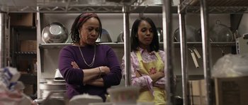 Movie still from “Mother and Child” (2009), directed by Rodrigo García – Two women standing next to each other in a kitchen; Medium shot, Over the shoulder angle