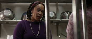 Movie still from “Mother and Child” (2009), directed by Rodrigo García – An older woman in a purple shirt is in a kitchen; Close Up shot, Over the shoulder angle