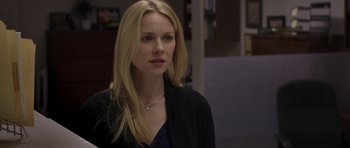 Movie still from “Mother and Child” (2009), directed by Rodrigo García – A woman with long blonde hair wearing a black top; Close Up shot, Over the shoulder angle