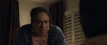 Movie still from “Mother and Child” (2009), directed by Rodrigo García – An older woman with dreadlocks is looking at the camera; Close Up shot, Over the shoulder angle