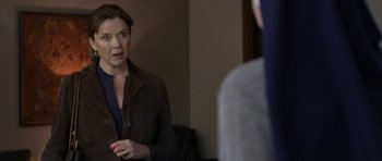 Movie still from “Mother and Child” (2009), directed by Rodrigo García – A woman standing in front of a mirror looking at herself in the mirror; Medium shot, Over the shoulder angle