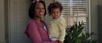 Movie still from “Mother and Child” (2009), directed by Rodrigo García – A woman holding a baby in her arms and smiling; Close Up shot, High angle