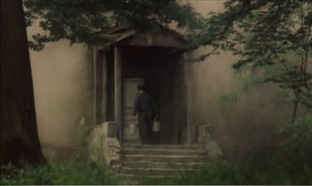 Movie still from “Mother and Son” (1997), directed by Aleksandr Sokurov – A man is walking up the steps of a house; Wide shot, Low angle