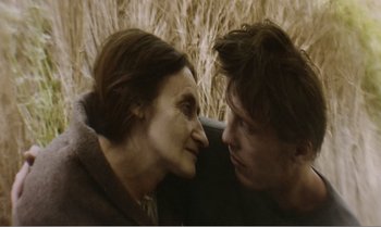 Movie still from “Mother and Son” (1997), directed by Aleksandr Sokurov – A woman and a young man face to face; Close Up shot, Over the shoulder angle