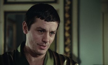 Movie still from “Mr. Klein” (1976), directed by Joseph Losey – A person wearing a green shirt; Close Up shot, Over the shoulder angle