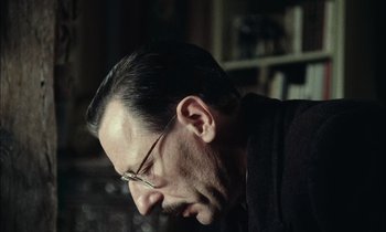 Movie still from “Mr. Klein” (1976), directed by Joseph Losey – A person wearing glasses; Close Up shot, Low angle