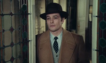 Movie still from “Mr. Klein” (1976), directed by Joseph Losey – A man wearing a hat and a coat; Medium shot, Over the shoulder angle