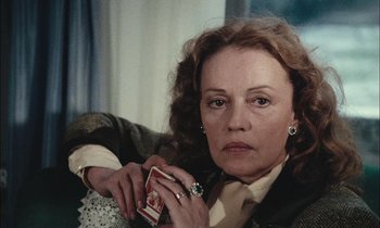 Movie still from “Mr. Klein” (1976), directed by Joseph Losey – A person holding a cigarette pack; Close Up shot, Over the shoulder angle