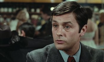 Movie still from “Mr. Klein” (1976), directed by Joseph Losey – A person wearing a suit and tie; Close Up shot, Over the shoulder angle