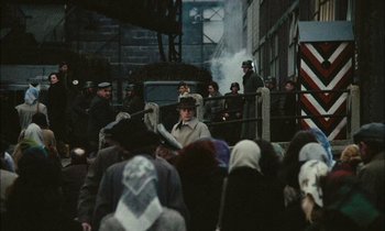 Movie still from “Mr. Klein” (1976), directed by Joseph Losey – A group of people standing in front of a building; Wide shot, High angle