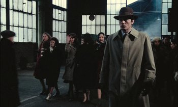 Movie still from “Mr. Klein” (1976), directed by Joseph Losey – A group of people standing in front of a building; Wide shot, Low angle