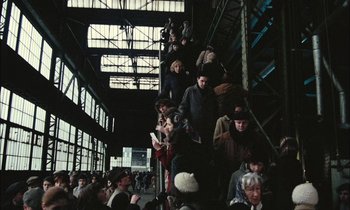 Movie still from “Mr. Klein” (1976), directed by Joseph Losey – A group of people standing on top of a set of stairs; Wide shot, High angle