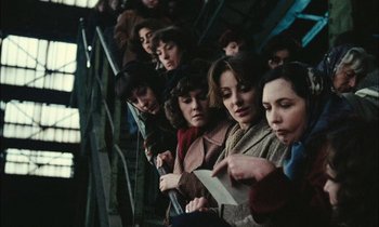 Movie still from “Mr. Klein” (1976), directed by Joseph Losey – A group of people standing in a line; Medium shot, High angle