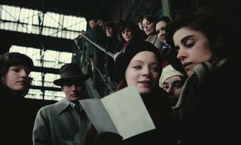 Movie still from “Mr. Klein” (1976), directed by Joseph Losey – A group of people standing on a set of stairs; Close Up shot, Low angle