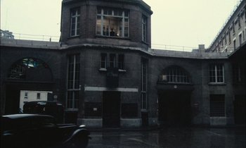 Movie still from “Mr. Klein” (1976), directed by Joseph Losey – A building that has a large window in the middle of it; Extreme Wide shot, Low angle