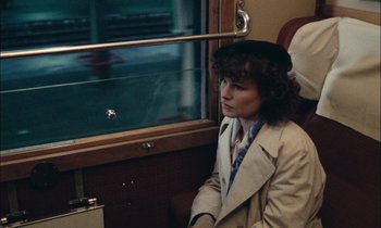 Movie still from “Mr. Klein” (1976), directed by Joseph Losey – A woman sitting on a train looking out the window; Close Up shot, High angle