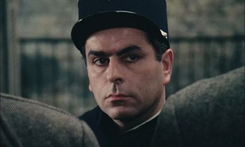 Movie still from “Mr. Klein” (1976), directed by Joseph Losey – A person wearing a uniform; Close Up shot, Over the shoulder angle