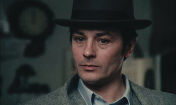 Movie still from “Mr. Klein” (1976), directed by Joseph Losey – A person wearing a hat; Close Up shot, Over the shoulder angle