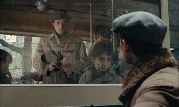 Movie still from “Mr. Klein” (1976), directed by Joseph Losey – A group of people standing in front of a mirror; Medium shot, Over the shoulder angle