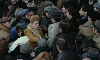 Movie still from “Mr. Klein” (1976), directed by Joseph Losey – A crowd of people standing around each other in the street; Medium shot, High angle
